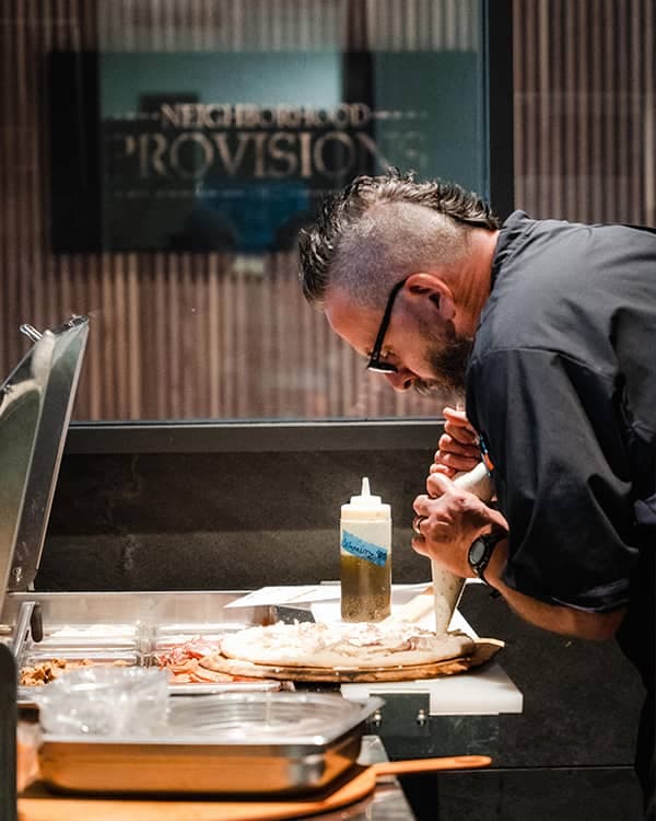 Chef plating a dish in the Neighborhood Provisions kitchen